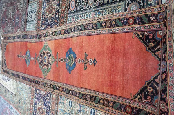 A Bidjar runner, Persian, the plain madder field with a sage medallion with pale indigo palmettes at each end, dark spandrels, a complementary leaf an