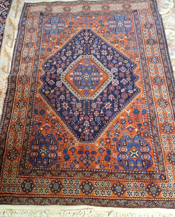 A Mahal rug, Persian, the indigo diamond field with a madder medallion, a madder surround with indigo corner medallions, all with minor motifs; a madd