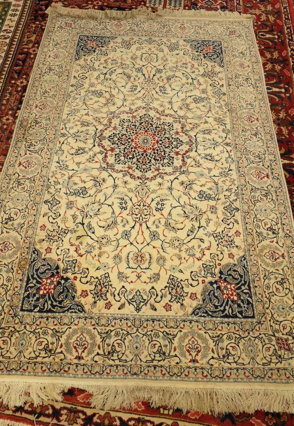 A fine part silk Nain rug, Persian, the ivory field with a central rosette medallion, dark indigo spandrels, all with delicate floral vines; a complem