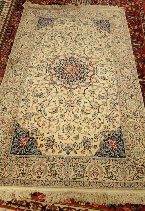 A fine part silk Nain rug, Persian, the ivory field with a central rosette medallion, dark indigo spandrels, all with delicate floral vines; a complem