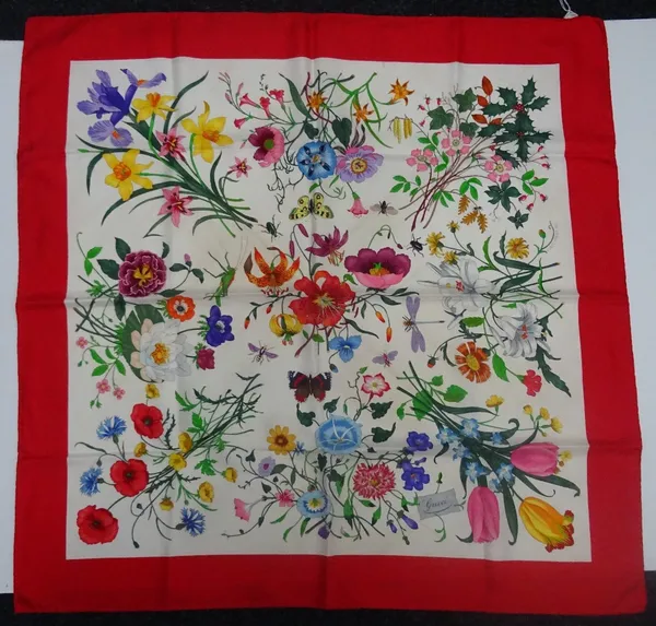 A Gucci 'Flora Spighe' silk scarf designed by Vittorio Accornero for Gucci, designed with floral sprays, butterflies and insects enclosed by a red bor