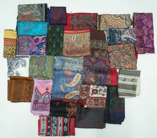 A large collection of twenty-five silk and wool scarves each printed with a paisley design, various sizes (25)