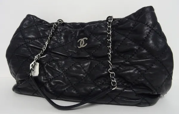 A Chanel black quilted leather tote bag, circa 2012-2013, with silver-tone hardware, two silver-tone chain and leather straps, with zipped interior an