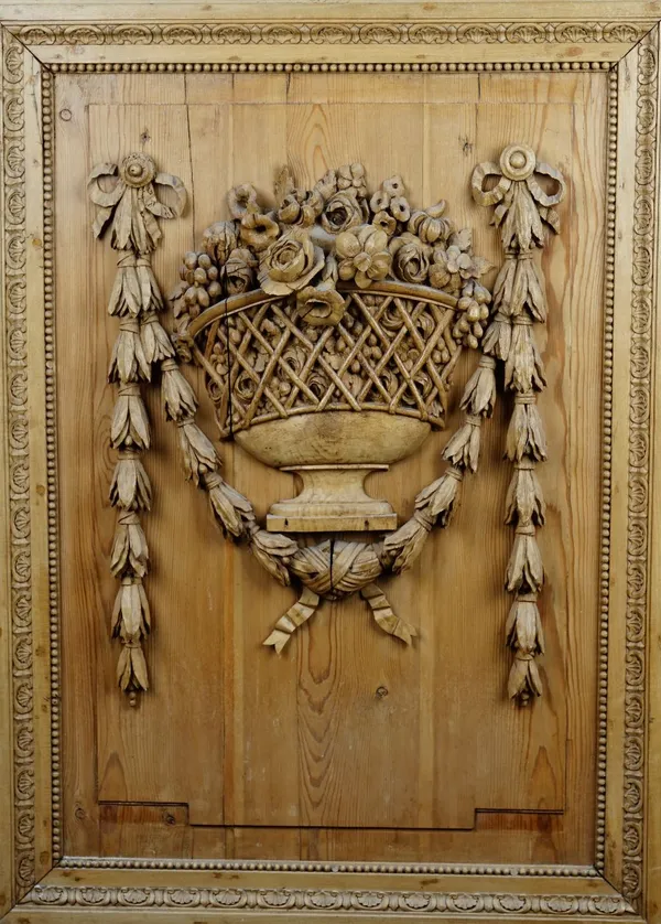 A 19th century pine and limewood relief carving depicting ribbon tied floral sprays in an open lattice goblet, 78cm wide x 107cm high.