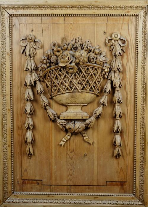 A 19th century pine and limewood relief carving depicting ribbon tied floral sprays in an open lattice goblet, 78cm wide x 107cm high.