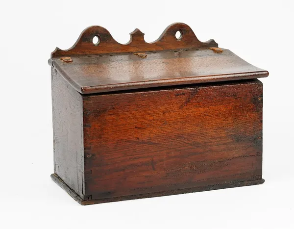 A George III oak candle box, the pierced and shaped back over a sloped front, 38cm wide x 31cm long.