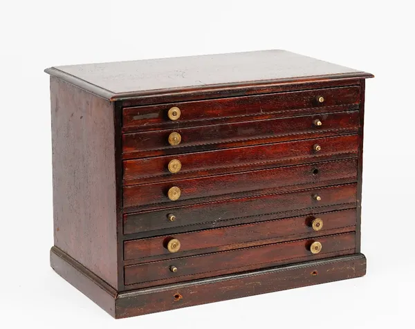 A 19th century mahogany table top collector's chest of seven long graduated drawers on a plinth base, 37cm wide x 28cm high.