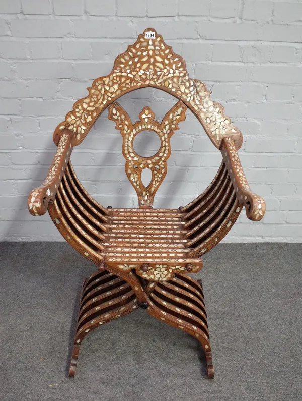 A late 19th century North African mother-of-pearl inlaid folding X-frame chair, of slatted construction, 60cm wide x 105cm high.