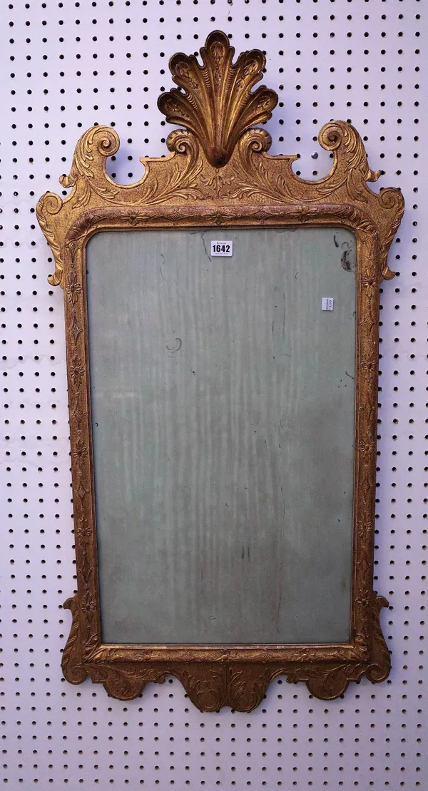 A George II style gilt framed mirror with shell crest and floral chased frame, 19th century, 55cm wide x 105cm high.