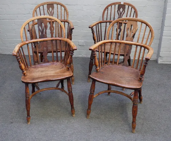 A set of three ash and elm Windsor elbow chairs, 19th century, with pierced splats, the ring turned legs united by crinoline stretchers, and another s