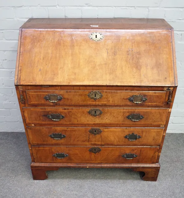 A mid-18th century featherbanded figured walnut bureau, the fitted interior over four long graduated drawers on bracket feet, 92cm wide x 108cm high.