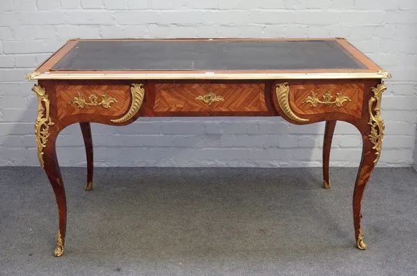 A Louis XV style gilt metal mounted kingwood bureau plat, the leather inset rectangular top over three frieze drawers on cabriole supports, 139cm wide