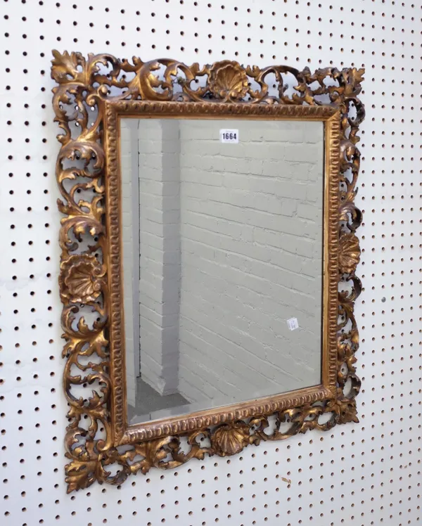 A Florentine gilt framed mirror with shell and acanthus chased frame and bevelled mirror plate, 58cm wide x  68cm high.