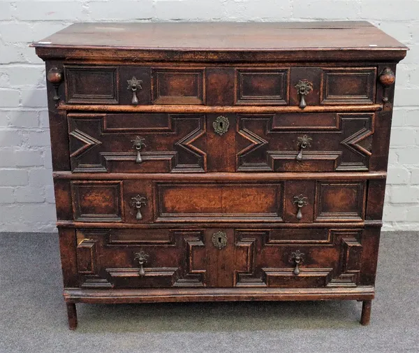 A Charles II oak and fruit wood chest with four long geometric moulded drawers, 97cm wide x 85cm high.