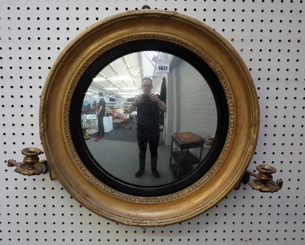 A 19th century gilt framed girandole convex wall mirror with ebonised slip and pair of candle sconces, 58cm wide.