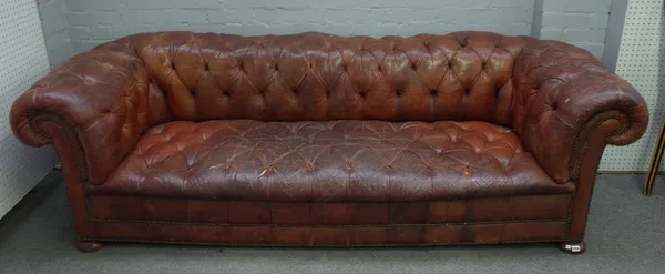 An early 20th century button back brown leather upholstered brass studded Chesterfield sofa, 242cm wide x 71cm high.