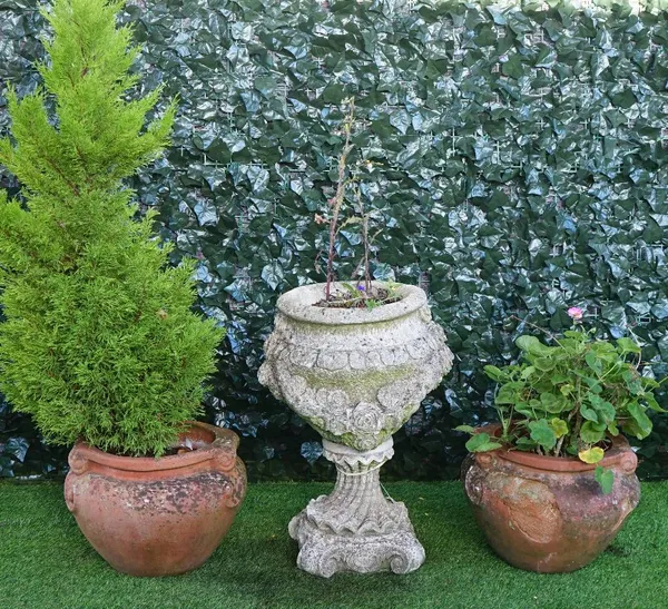 A pair of Compton style terracotta scroll garden pots, 44cm wide x 32cm high, together with a reconstituted stone jardiniere with floral moulded body