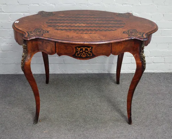 A Louis XV style kingwood, rosewood, ebonised inlaid and gilt metal mounted writing table, circa 1870, of shaped oval outline, inlaid with foliate pan