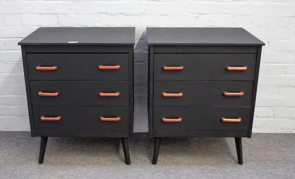 A pair of 20th century ebonised three drawer bedside chests, with metal inlaid teak handles on tapering splayed supports, 60cm wide x 74cm high.