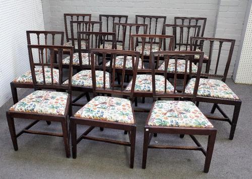 A set of sixteen George III mahogany stick back dining chairs on tapering square supports, 154cm wide x 86cm high (16).