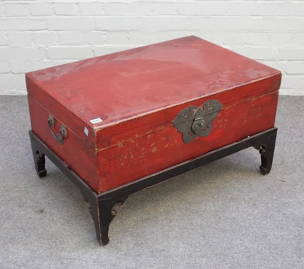 A 19th century Chinese scarlet lacquered rectangular trunk, on later ebonised stand, 78cm wide x 45cm high.