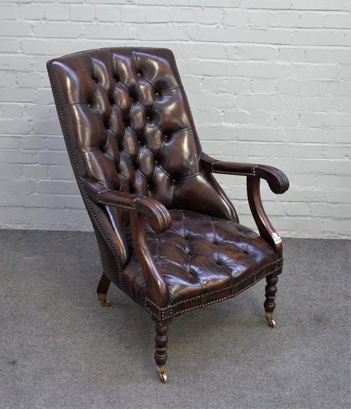 An early Victorian style mahogany framed open armchair, with brown leather upholstery, on turned supports, 58cm wide x 99cm high.