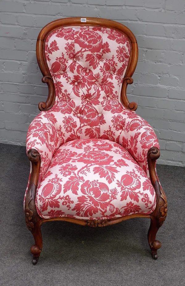 A Victorian mahogany framed spoonback easy armchair, with serpentine seat on scroll supports, 70cm wide x 101cm high.