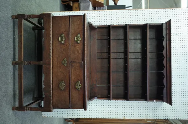 An 18th century oak dresser, the enclosed three tier plate rack with two short and one long drawer on block supports, 113cm wide x 193cm high.