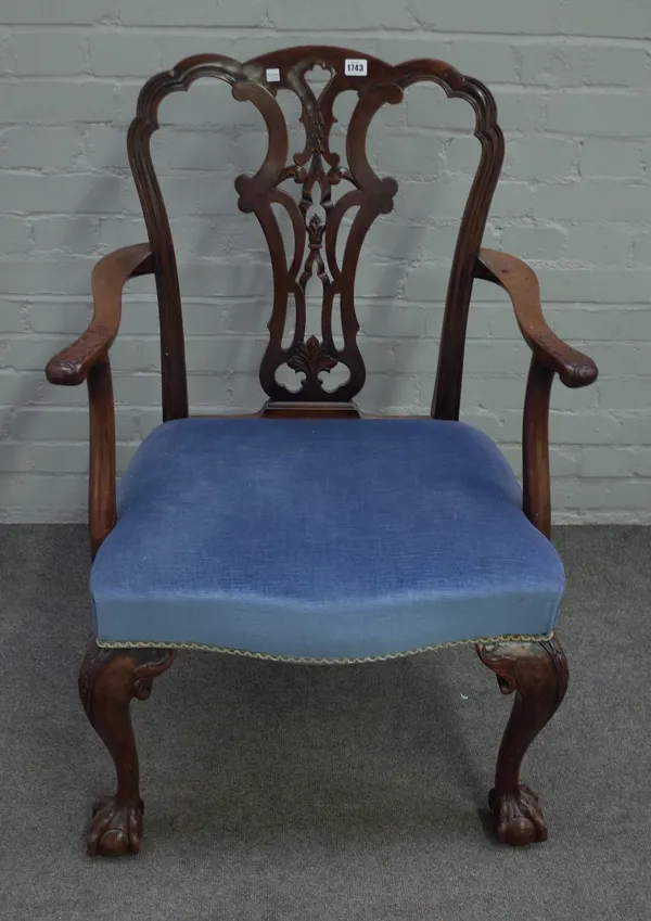 A mid-18th century style mahogany open armchair with serpentine seat and claw and ball feet, 66cm wide x 100cm high.