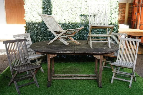 A teak oval extending garden table, 100cm wide x 180cm x long x 240cm long extended, together with six folding chairs, (7).