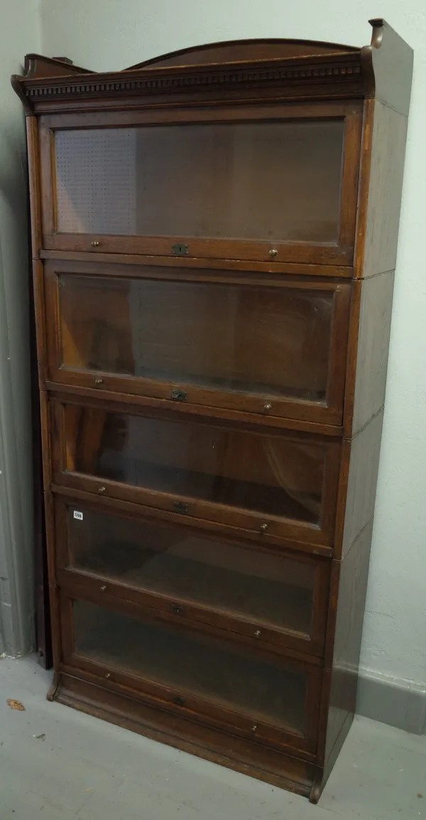 The Lebus bookcase, oak five section glazed bookcase with up and over doors on plinth base, 88cm wide x 177cm high.