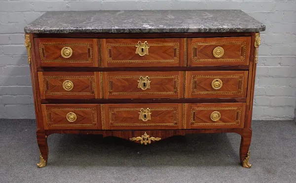 A Louis XV style gilt metal mounted parquetry inlaid kingwood commode, the marble top over three short and two long drawers on squat scroll supports,