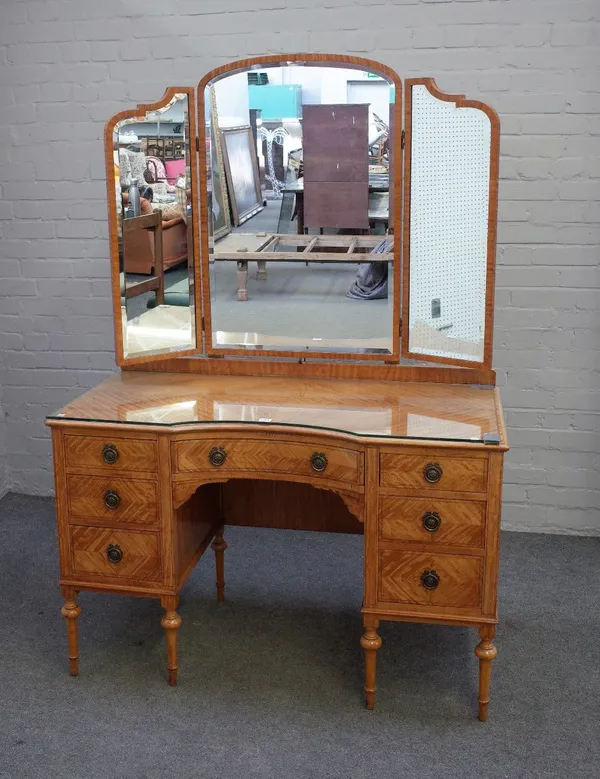 A late 19th/early 20th  century satinwood dressing table, the bevelled triptych mirror above an inverted seven drawer base on turned supports, 122cm w