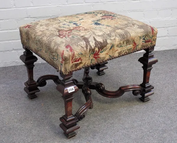 A 17th century style walnut framed rectangular footstool, on square baluster supports, united by shaped X-frame stretcher, 58cm wide x 46cm high.