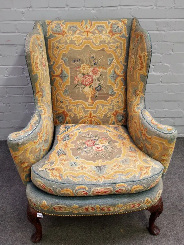 A George II wingback easy armchair with bow seat on shell capped pad supports, 84cm wide x 103cm high. 6909