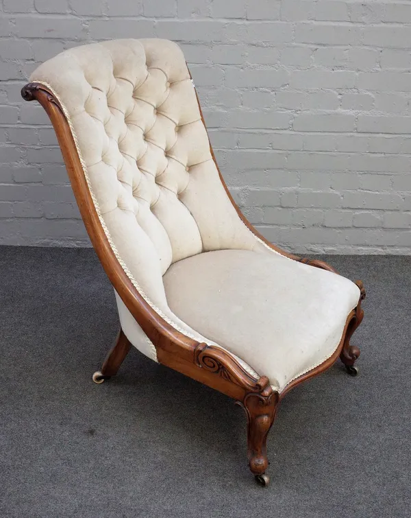 A Victorian walnut slipper back easy chair on scroll supports, 58cm wide x 92cm high.