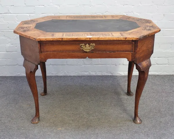 A 17th century seaweed marquetry inlaid oak and walnut centre table, the compressed octagonal top with inset polished slate panel over a frieze drawer