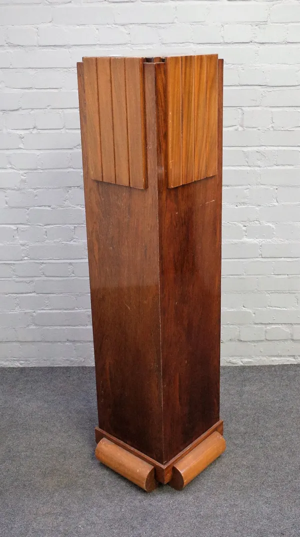 An Art Deco walnut plinth of stepped square form, on split turned base, 40cm wide x 135cm high.