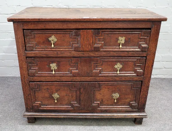 A 17th century oak chest with three long geometric moulded drawers on stile feet, 91cm wide x 80cm high.