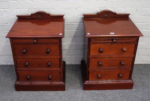 A pair of mahogany bedside tables with shallow drawer over three further on plinth base, 47cm wide x 67cm high.