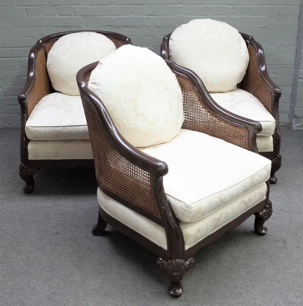 A 20th century mahogany framed four piece bergere suite to comprise sofa, 204cm wide x 84cm high, and three matching armchairs, 71cm wide x 84cm long