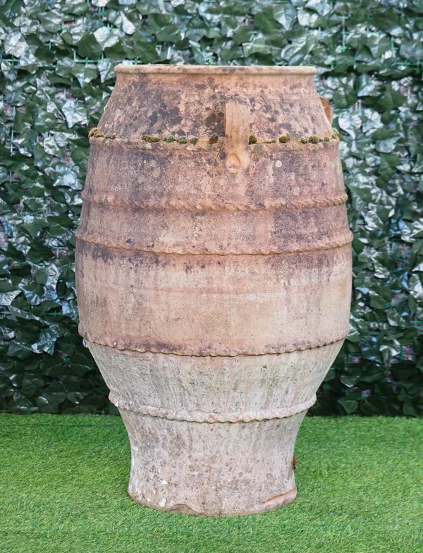 A large terracotta baluster shaped oil jar with three lug handles, 55cm wide x 87cm high, (a.f).