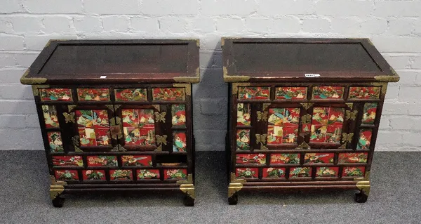 A pair of Eastern metal bound hardwood side cabinets, each with an arrangement of drawers and cupboards decorated with Eastern figure, 62cm wide x 58c