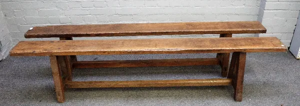 A pair of 19th century French oak benches, each on four square supports united by stretcher, 193cm wide x 42cm high.