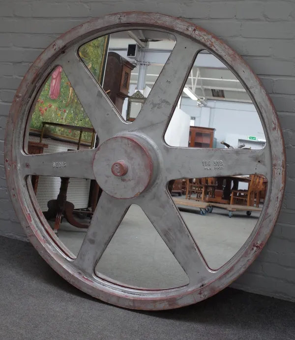 A pair of modern silver painted circular wall mirrors formed as 19th century cast iron six-spoke wheels, 143cm diameter (2).