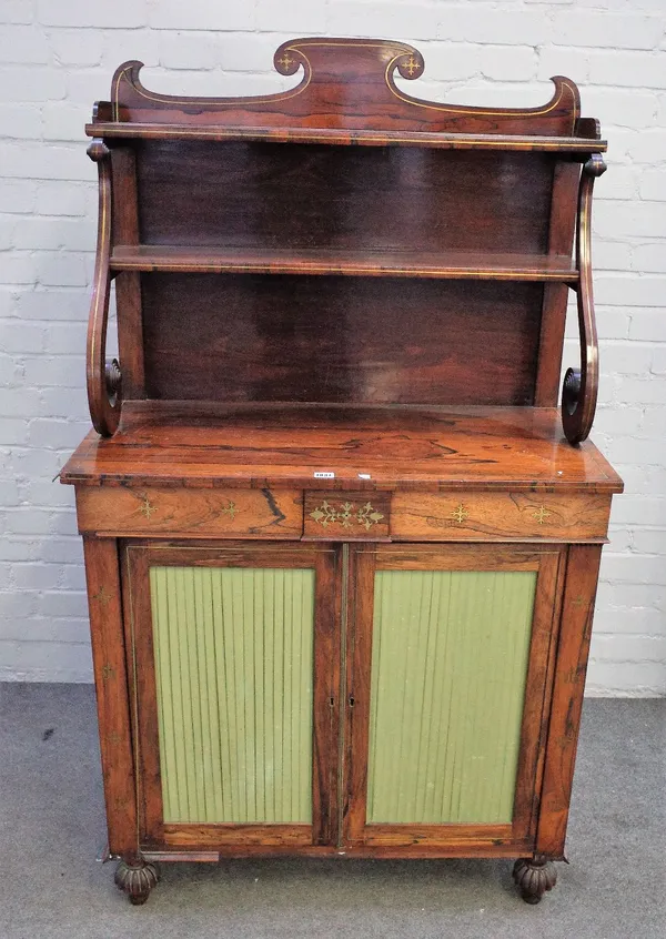 A Regency brass inlaid rosewood chiffonier, the two tier shelf back over a pair of frieze drawers and pleated silk cupboards on melon carved feet, 91c