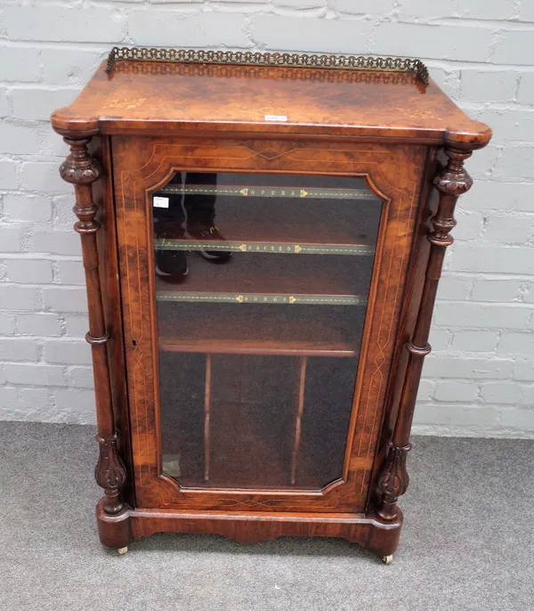 A Victorian burr walnut boxwood strung and foliate inlaid music cabinet, the glazed door flanked by turned columns, 66cm wide x 39cm deep x 101cm high