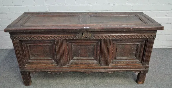 A 17th century oak coffer with twin panel lid over triple moulded panel front on stile feet, 120cm wide x 50cm high.