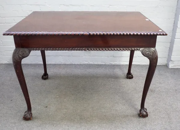 An 18th century style mahogany silver table, the gadrooned rectangular top on ball and claw supports, 119cm wide x  82cm high.