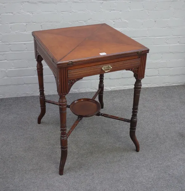 An Edwardian walnut envelope top card table, stamped 'Edwards & Roberts' with frieze drawer, on ring turned splayed legs united by an undertier, 53cm